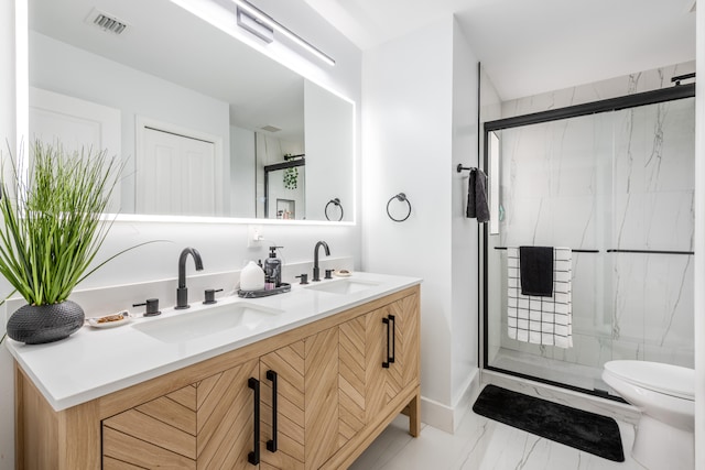 bathroom with vanity, toilet, and walk in shower