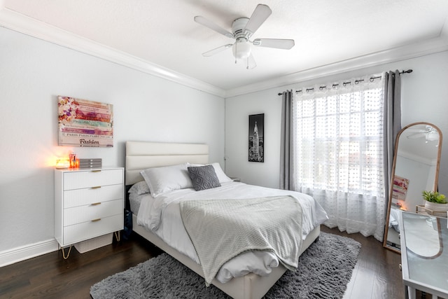 bedroom with ornamental molding, dark hardwood / wood-style floors, and ceiling fan