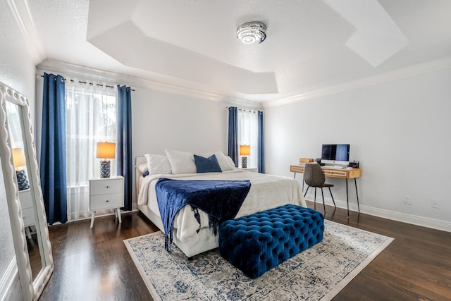 bedroom featuring ornamental molding, a tray ceiling, and dark hardwood / wood-style floors