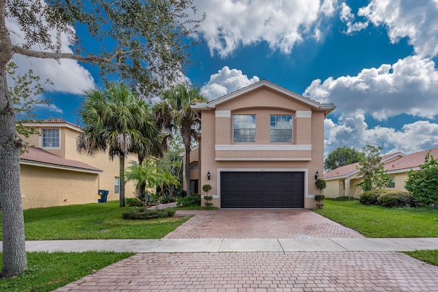 view of front facade with a front yard and a garage