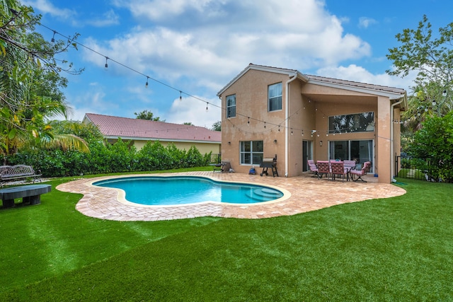 view of swimming pool with a patio area and a lawn