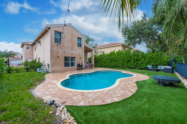 view of pool with a patio area and a yard