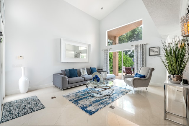 living room with a textured ceiling, high vaulted ceiling, and tile patterned flooring