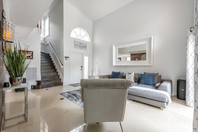 tiled living room featuring high vaulted ceiling