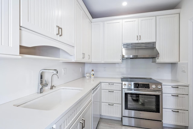 kitchen with stainless steel electric stove, sink, white cabinets, and white dishwasher