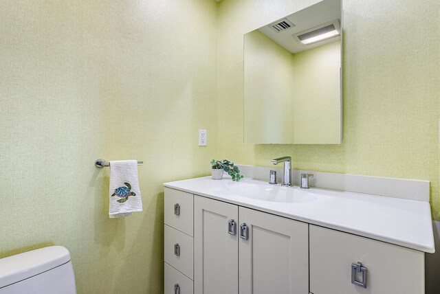 bathroom featuring vanity and toilet