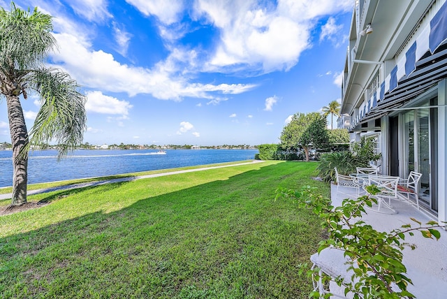 view of yard featuring a water view and a patio area