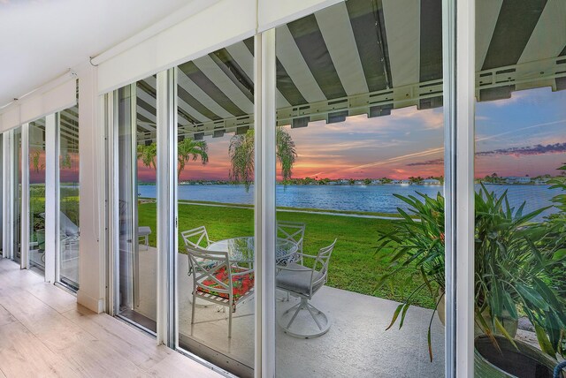 entryway featuring a water view and light hardwood / wood-style floors