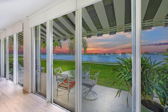 doorway featuring a water view and wood finished floors