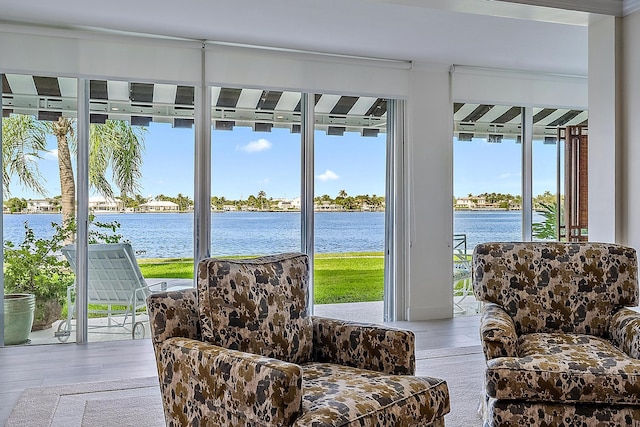 sunroom featuring a water view