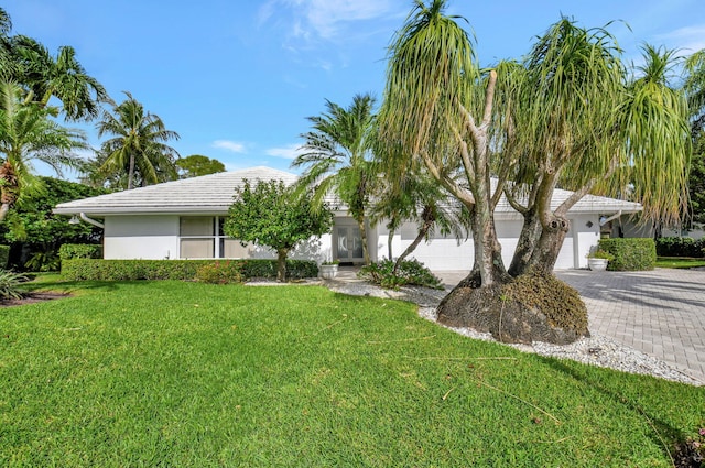 view of front facade with a garage and a front lawn