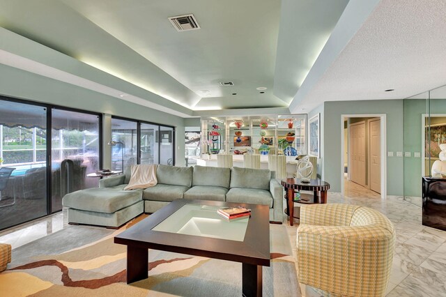 living room with a textured ceiling and ceiling fan