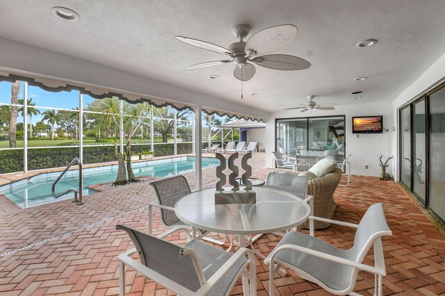 view of swimming pool featuring glass enclosure and a patio area