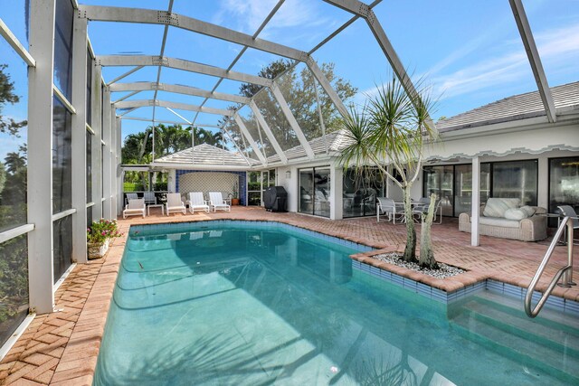 view of pool featuring glass enclosure