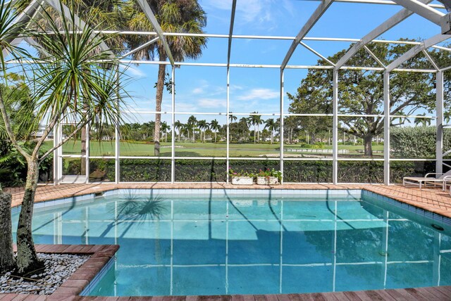 view of swimming pool with a lanai and a patio area