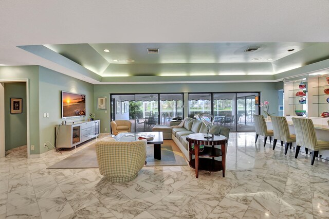 dining room with a raised ceiling and plenty of natural light