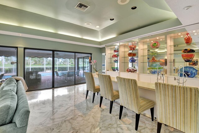 living room featuring a raised ceiling