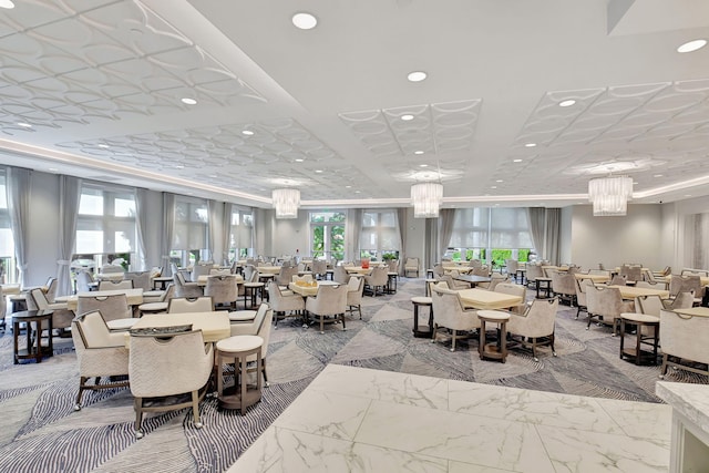 dining space with a wealth of natural light and a chandelier