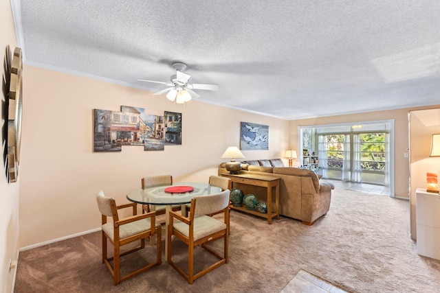 carpeted dining area with ceiling fan, a textured ceiling, and ornamental molding