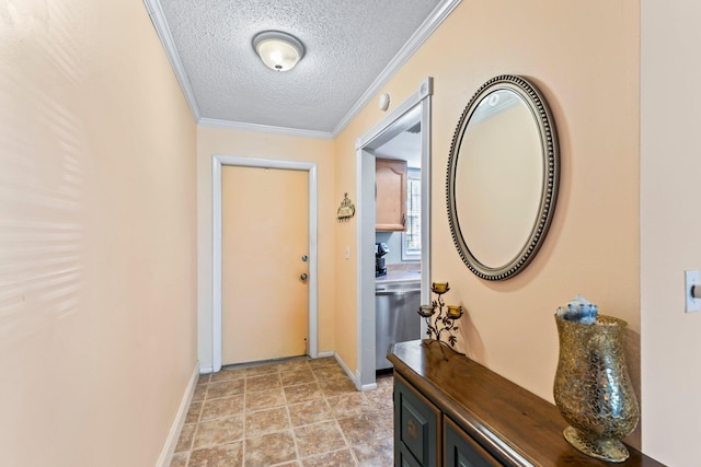 entryway with ornamental molding and a textured ceiling