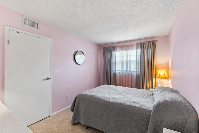 carpeted bedroom with a textured ceiling