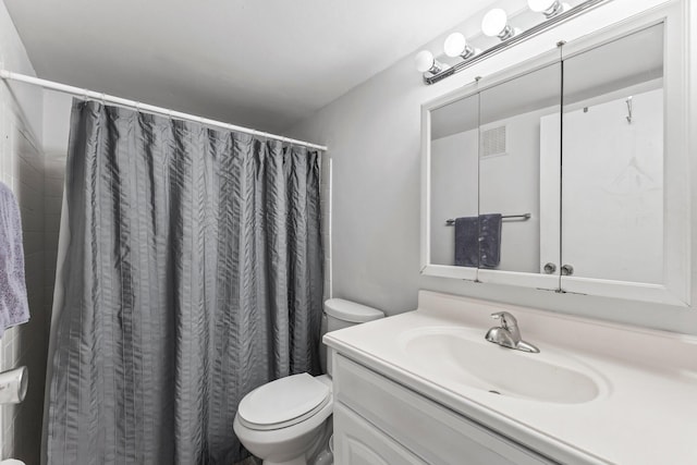 bathroom with toilet, vanity, and a shower with shower curtain