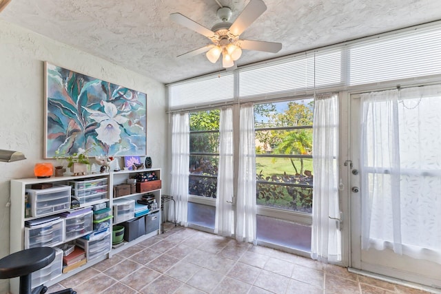 2950 SE Ocean Blvd Unit 38-2, Stuart, FL 34996 - interior space with light tile patterned floors, a textured wall, a ceiling fan, and a textured ceiling