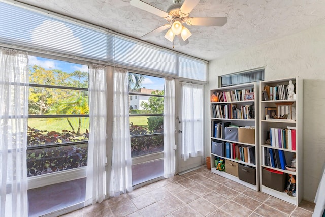 entryway featuring light tile patterned flooring and ceiling fan