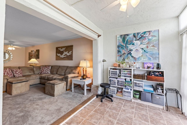 2950 SE Ocean Blvd Unit 38-2, Stuart, FL 34996 - living room featuring tile patterned flooring, a ceiling fan, a textured ceiling, and carpet floors