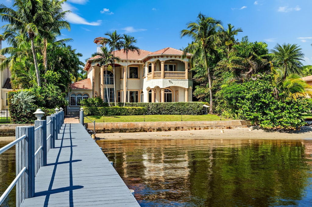 view of dock with a water view and a balcony