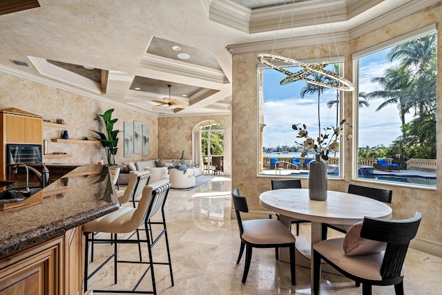 dining area featuring sink, crown molding, ceiling fan, and plenty of natural light