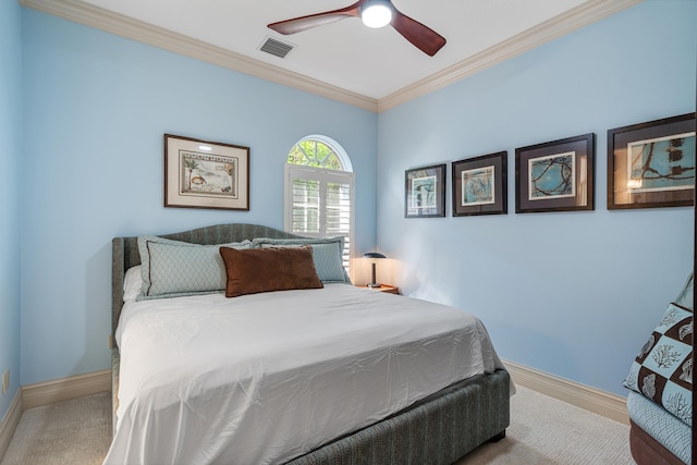 bedroom with ceiling fan, ornamental molding, and carpet floors