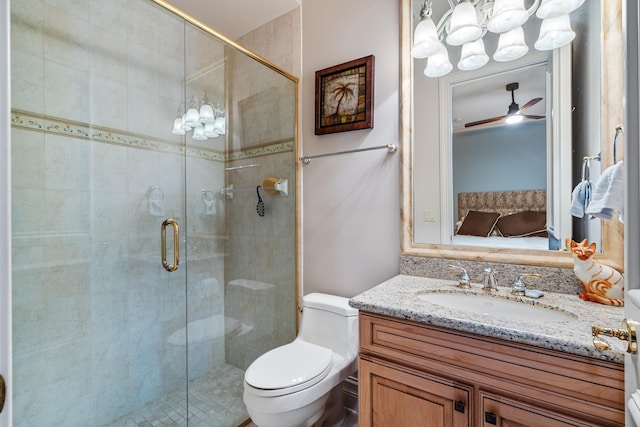 bathroom featuring toilet, walk in shower, vanity, and ceiling fan