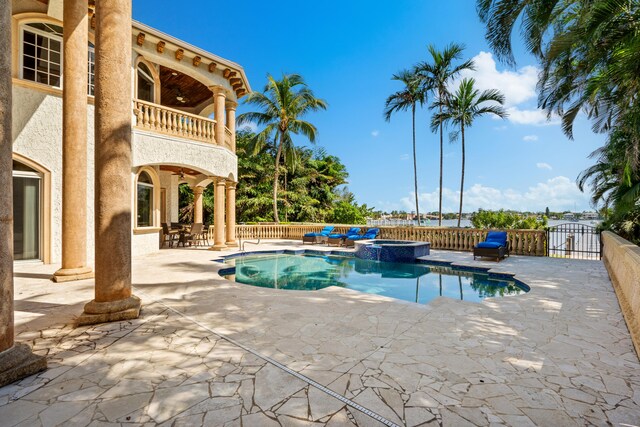 view of swimming pool with an in ground hot tub and a patio area