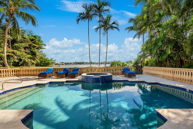 view of pool with an in ground hot tub and a patio area