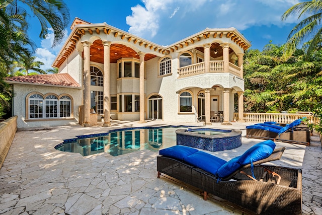 view of pool with an in ground hot tub and a patio