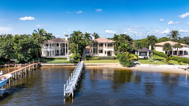 view of dock featuring a water view and a balcony