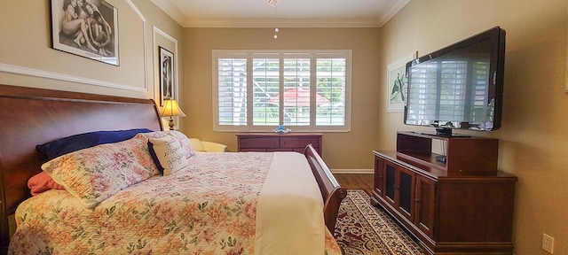 sitting room with hardwood / wood-style floors, ceiling fan, and crown molding