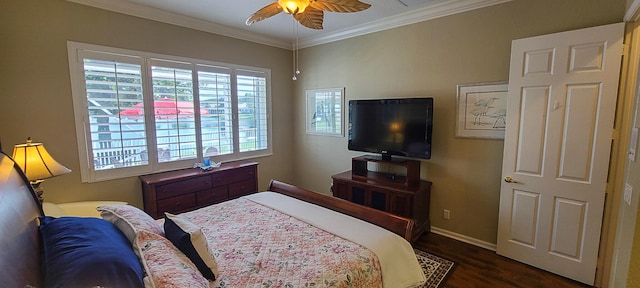 bedroom featuring dark hardwood / wood-style flooring, ceiling fan, and crown molding