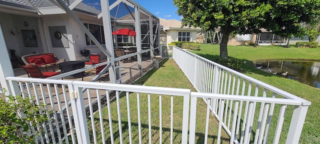 view of yard with a water view and a lanai