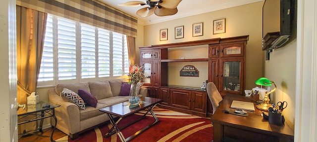 sitting room featuring hardwood / wood-style floors, ceiling fan, and ornamental molding