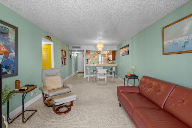 living room with light carpet, an inviting chandelier, and a textured ceiling