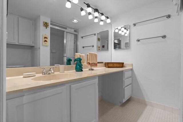 bathroom featuring vanity, a shower, and tile patterned flooring