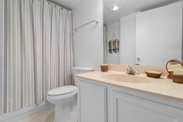 bathroom featuring tile patterned floors, vanity, and toilet