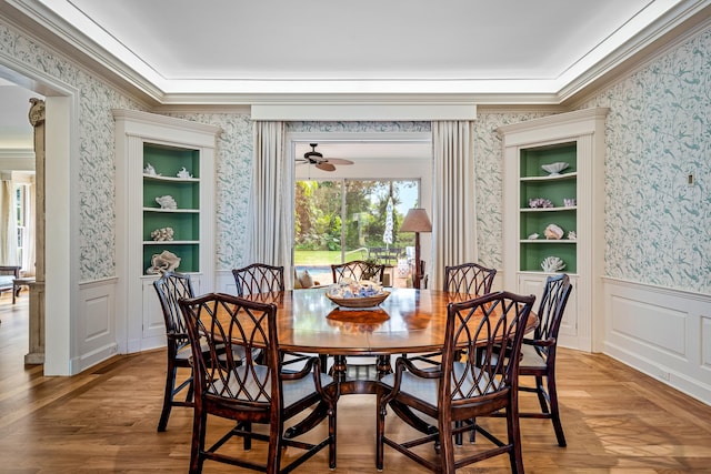 dining area with hardwood / wood-style floors, built in features, ceiling fan, and ornamental molding