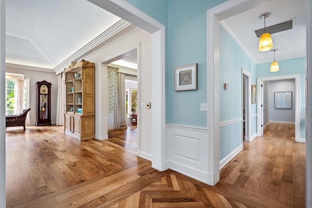 hallway with ornamental molding and hardwood / wood-style flooring