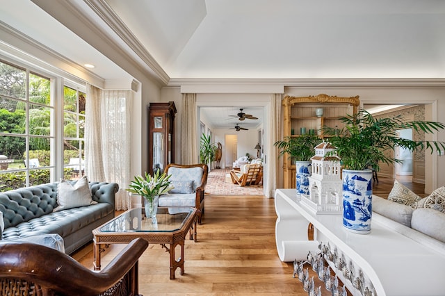 living room featuring ornamental molding, hardwood / wood-style flooring, ceiling fan, and vaulted ceiling