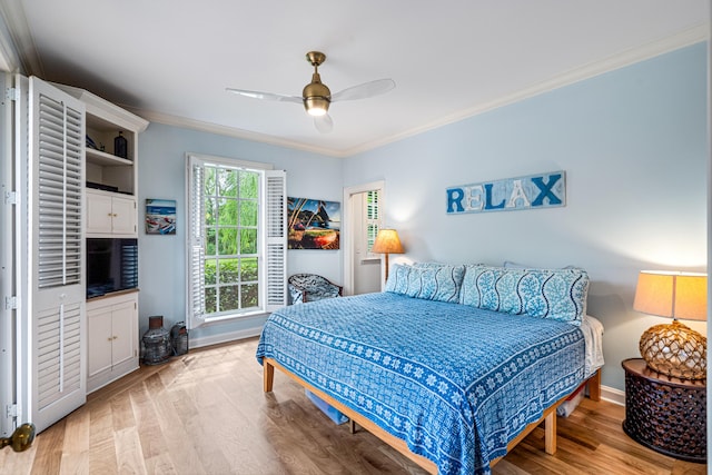 bedroom with ceiling fan, light wood-type flooring, and crown molding