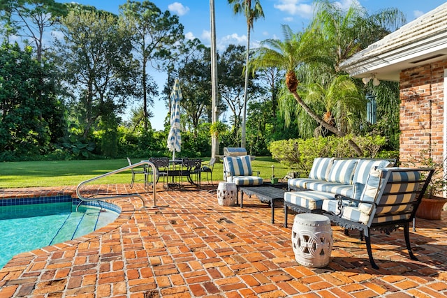 view of pool with a yard, a patio, and an outdoor living space