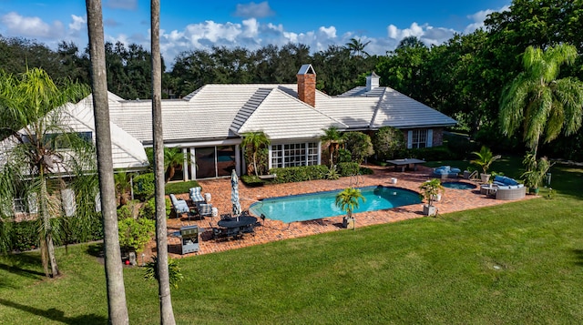 view of pool featuring a lawn and a patio